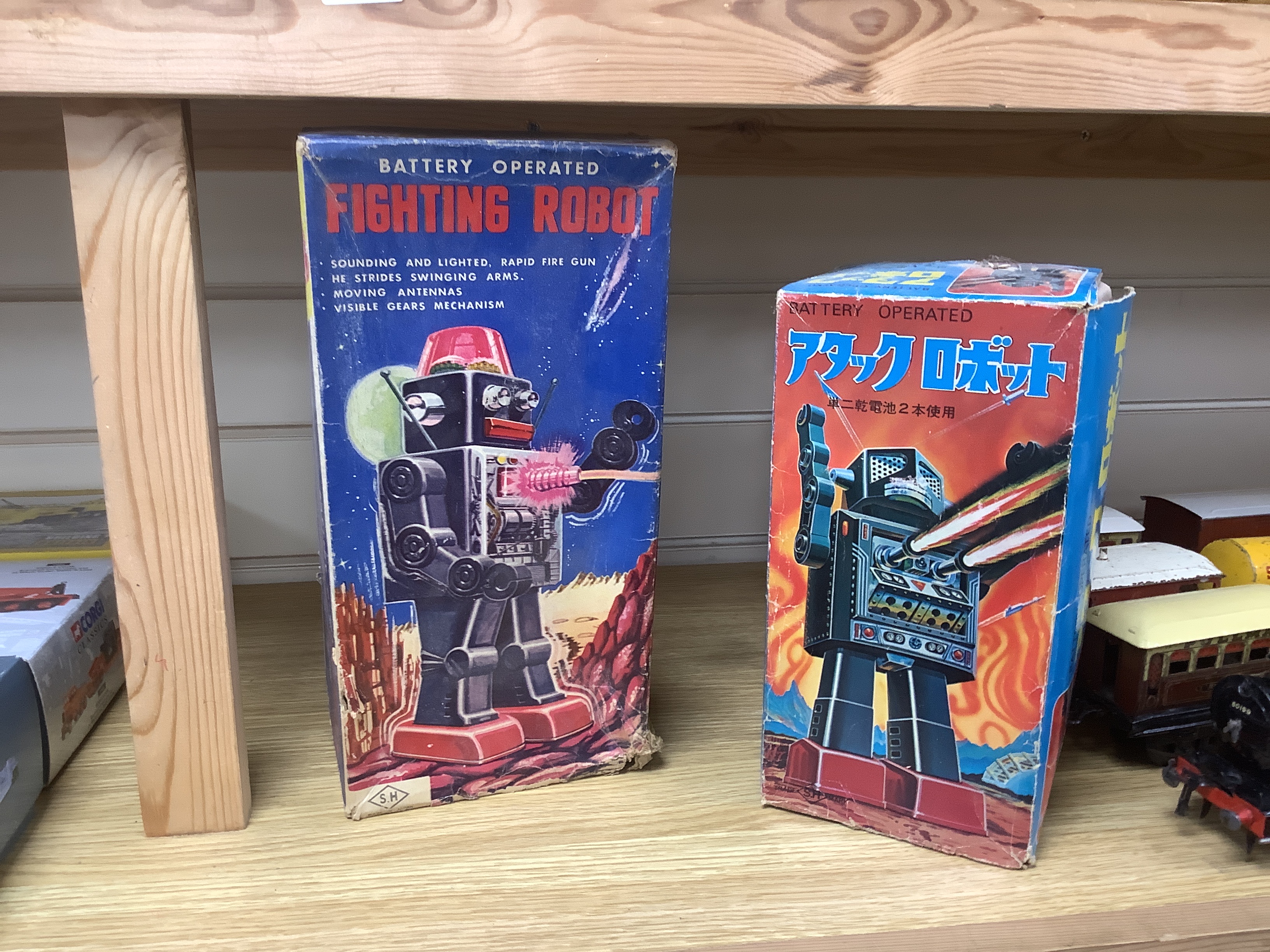 Four 1960s Japanese battery and clockwork powered robots, including; a boxed Horikawa (SH Toys) Fighting Robot, another smaller example by Horikawa, a Yoshiya (KO) silver robot and a Yoshhiya black clockwork robot, talle